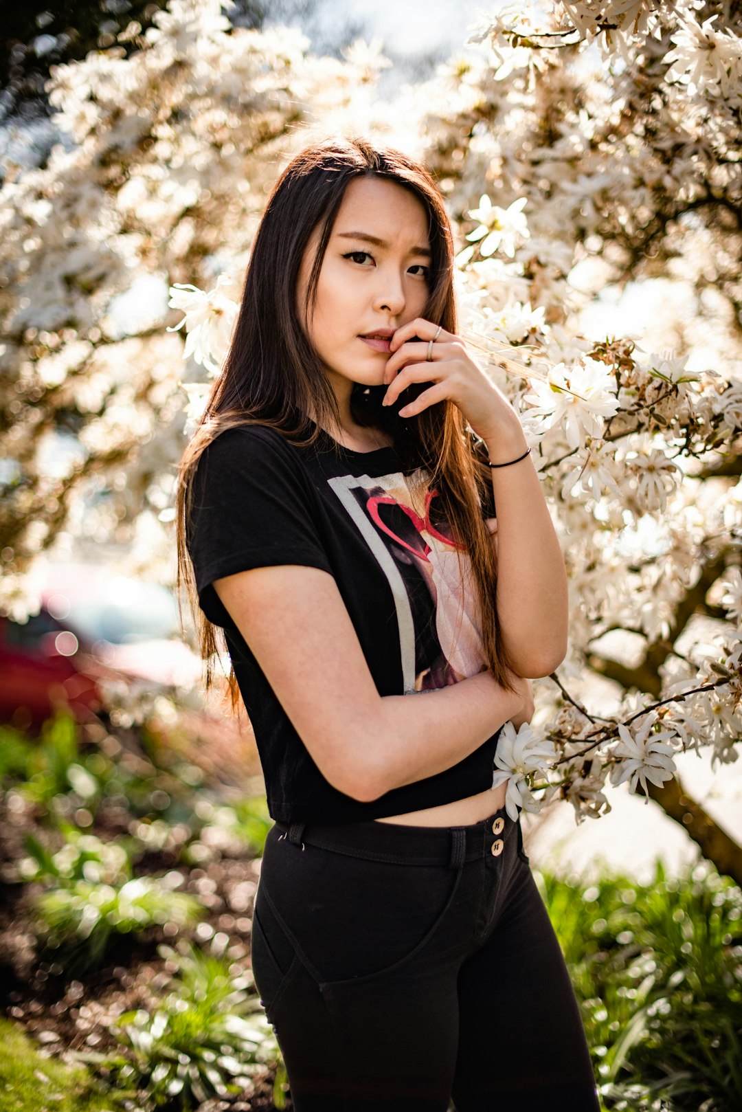 woman in black t-shirt standing under tree