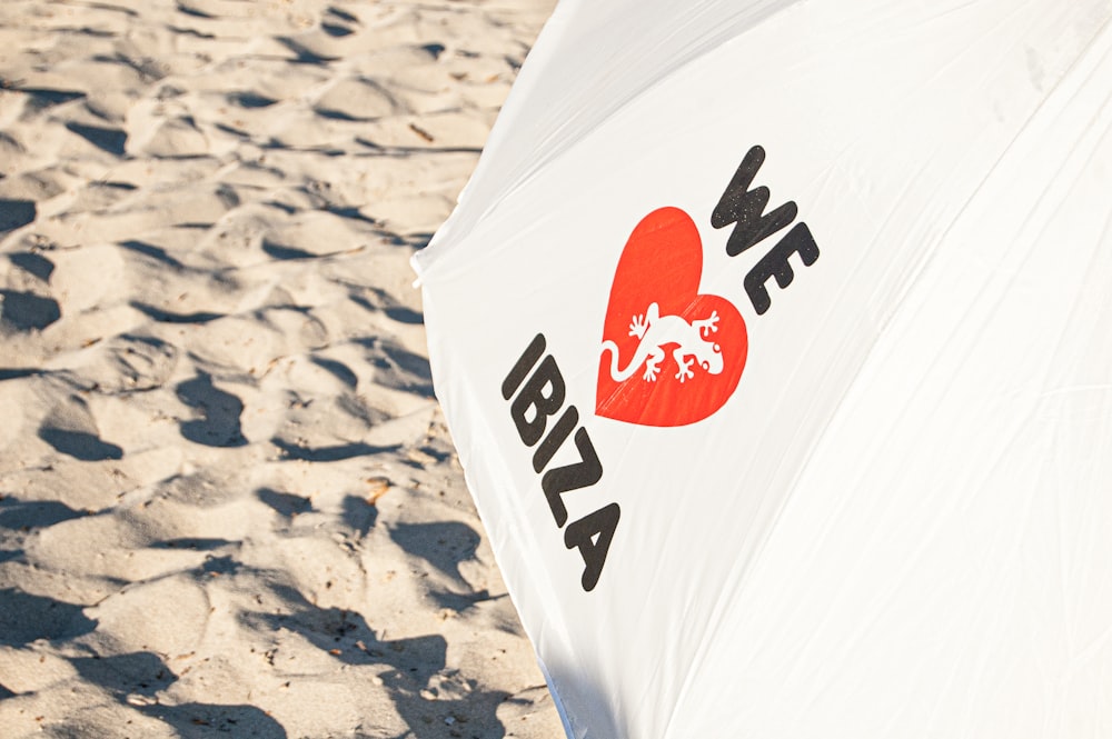 white and red flag on beach