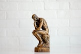 brown concrete statue of man