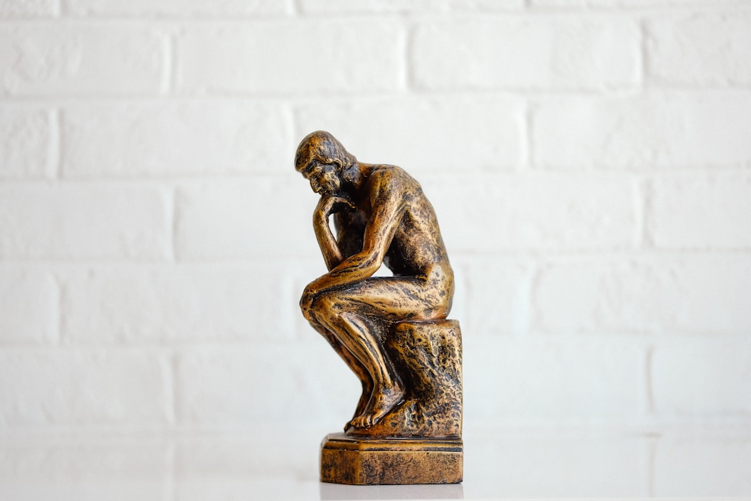 brown concrete statue of man,
