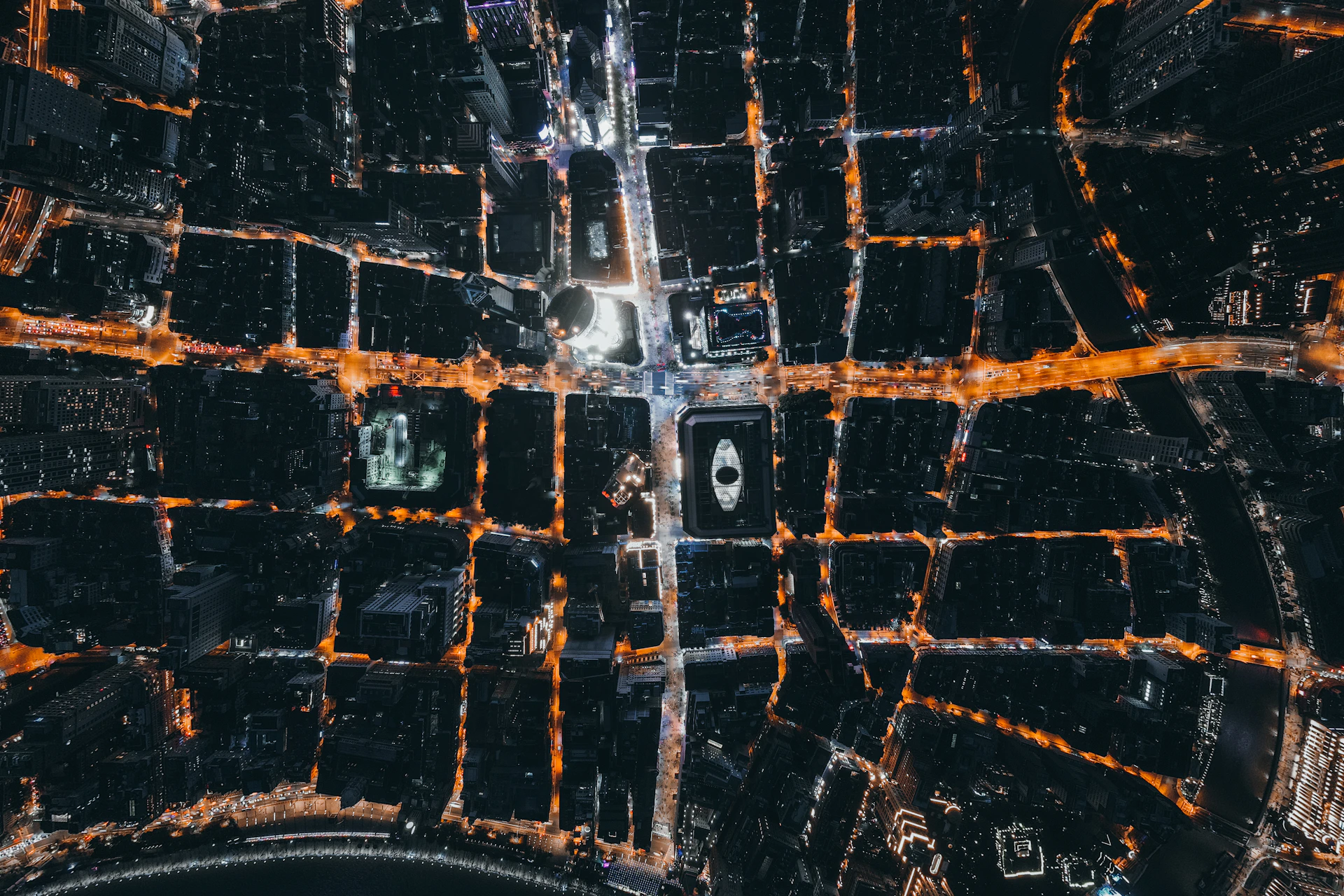 Top-down aerial surveillance view of a city grid at night