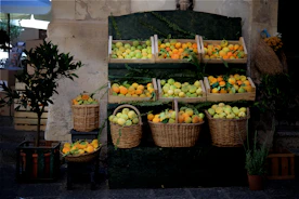Fresh tropical fruits displayed in a rustic wooden crate with natural lighting
