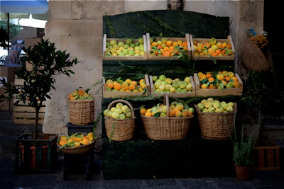 Fresh tropical fruits displayed in a rustic wooden crate with natural lighting
