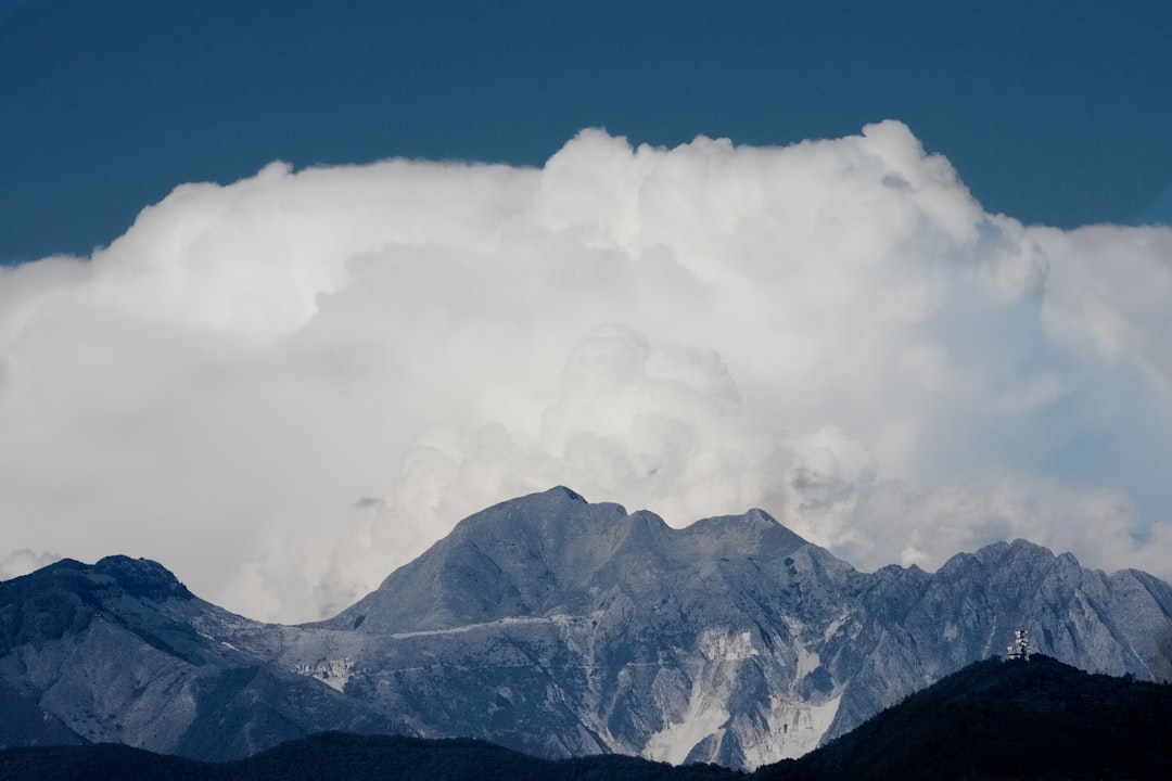 white clouds over snow covered mountain