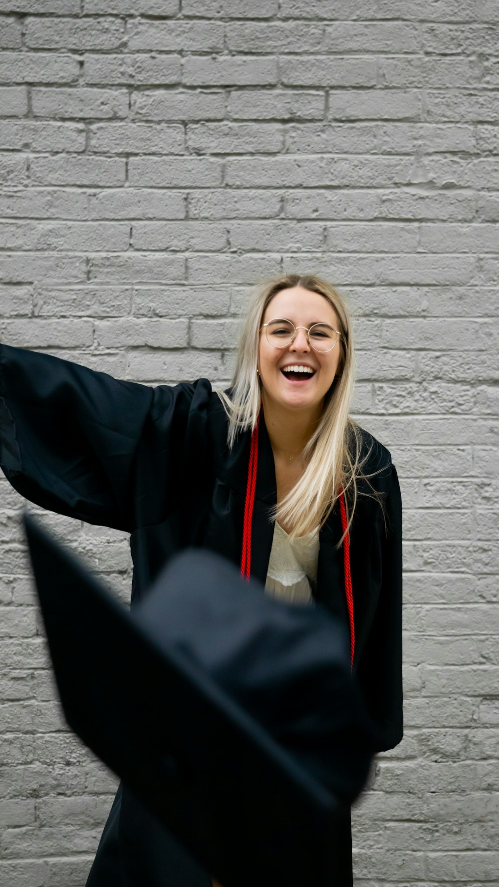 woman in black academic gown smiling