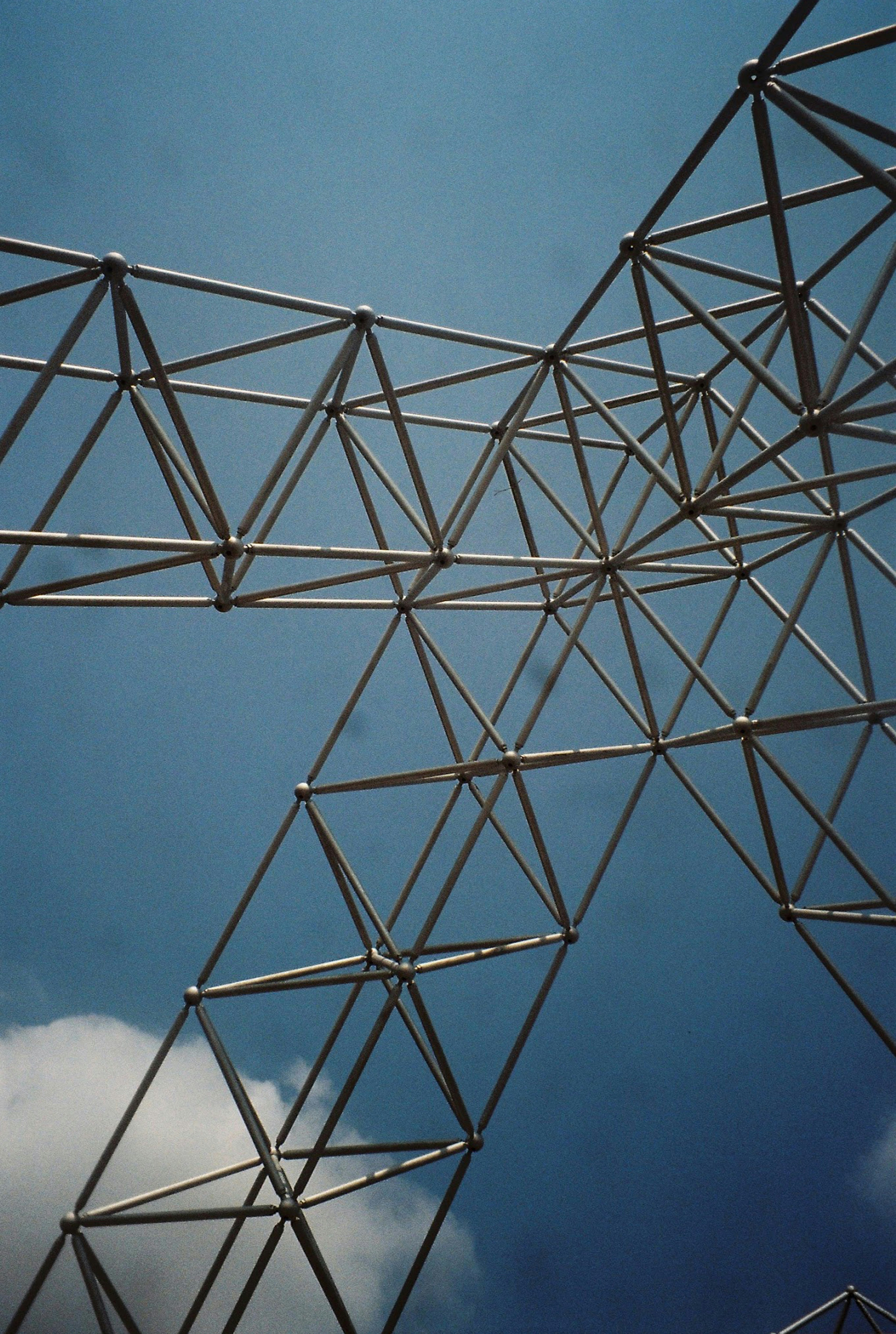 a plane flying through a blue cloudy sky