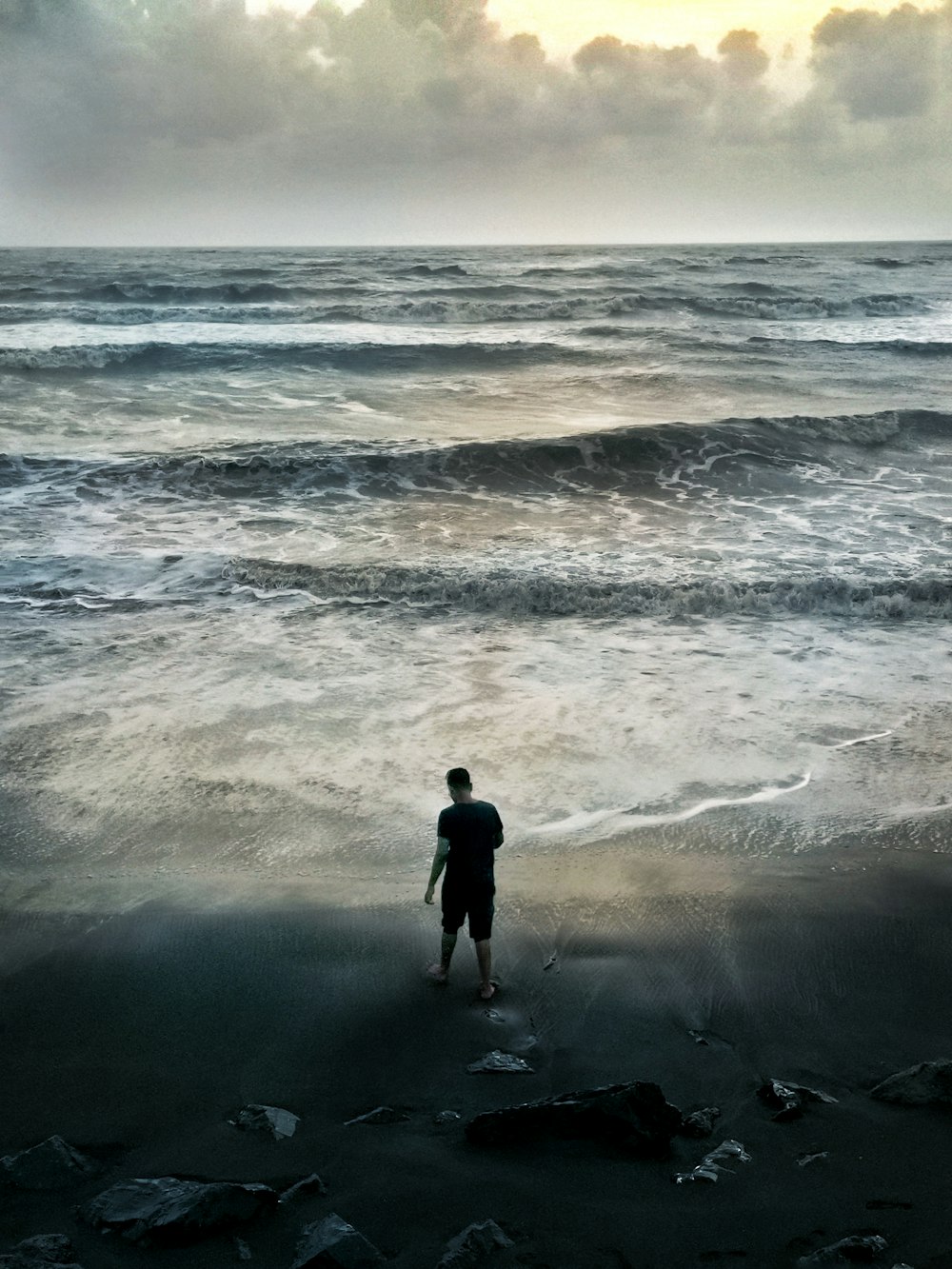 2 person standing on seashore during daytime