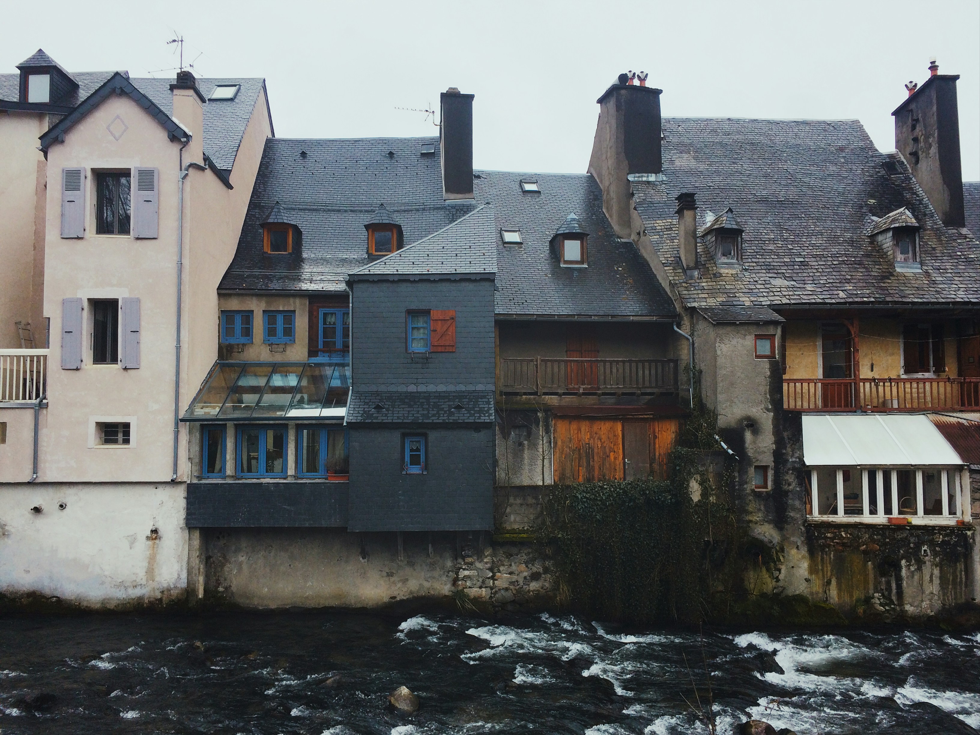 gray and brown concrete building near body of water during daytime