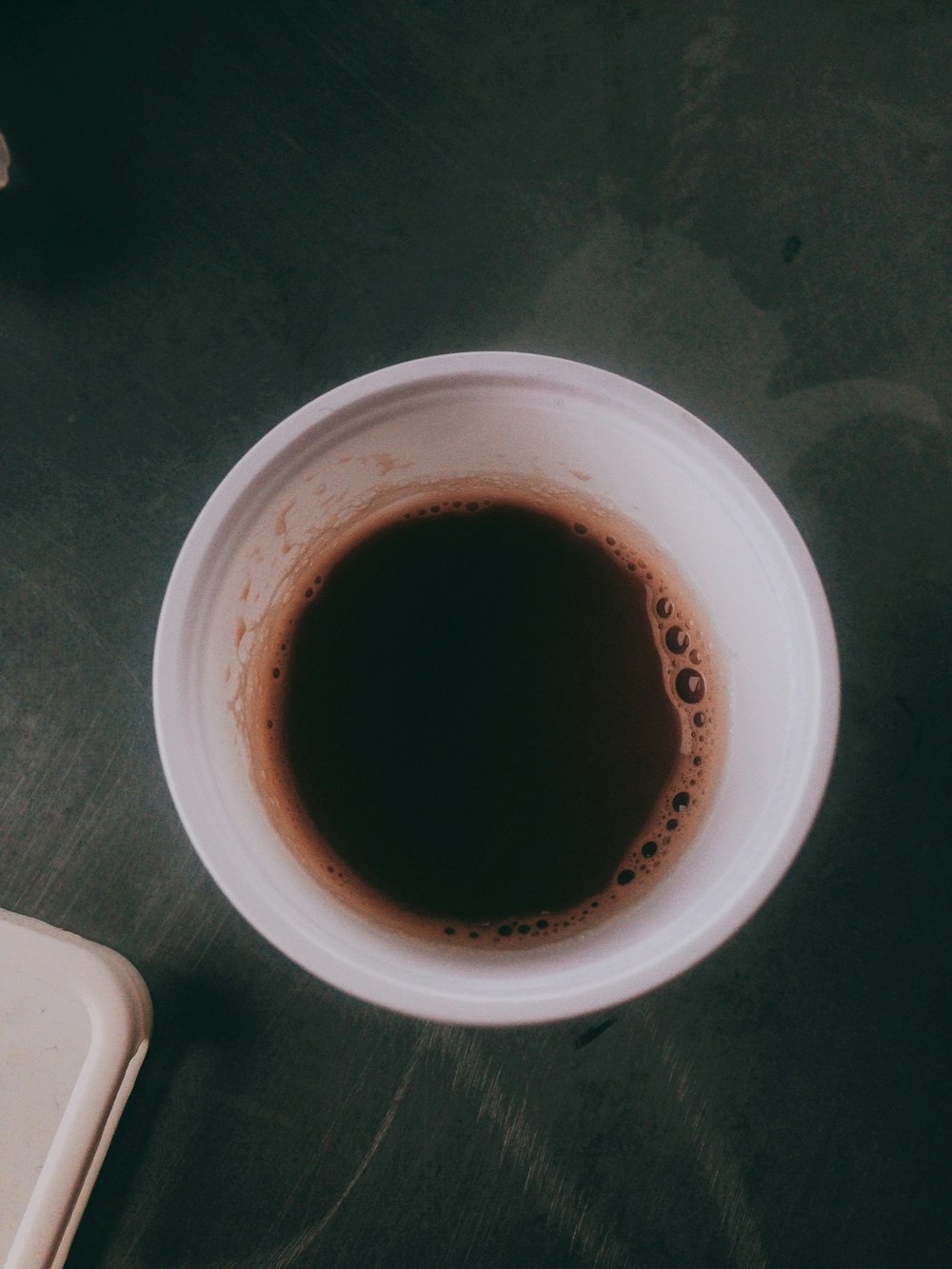 white ceramic mug with brown liquid