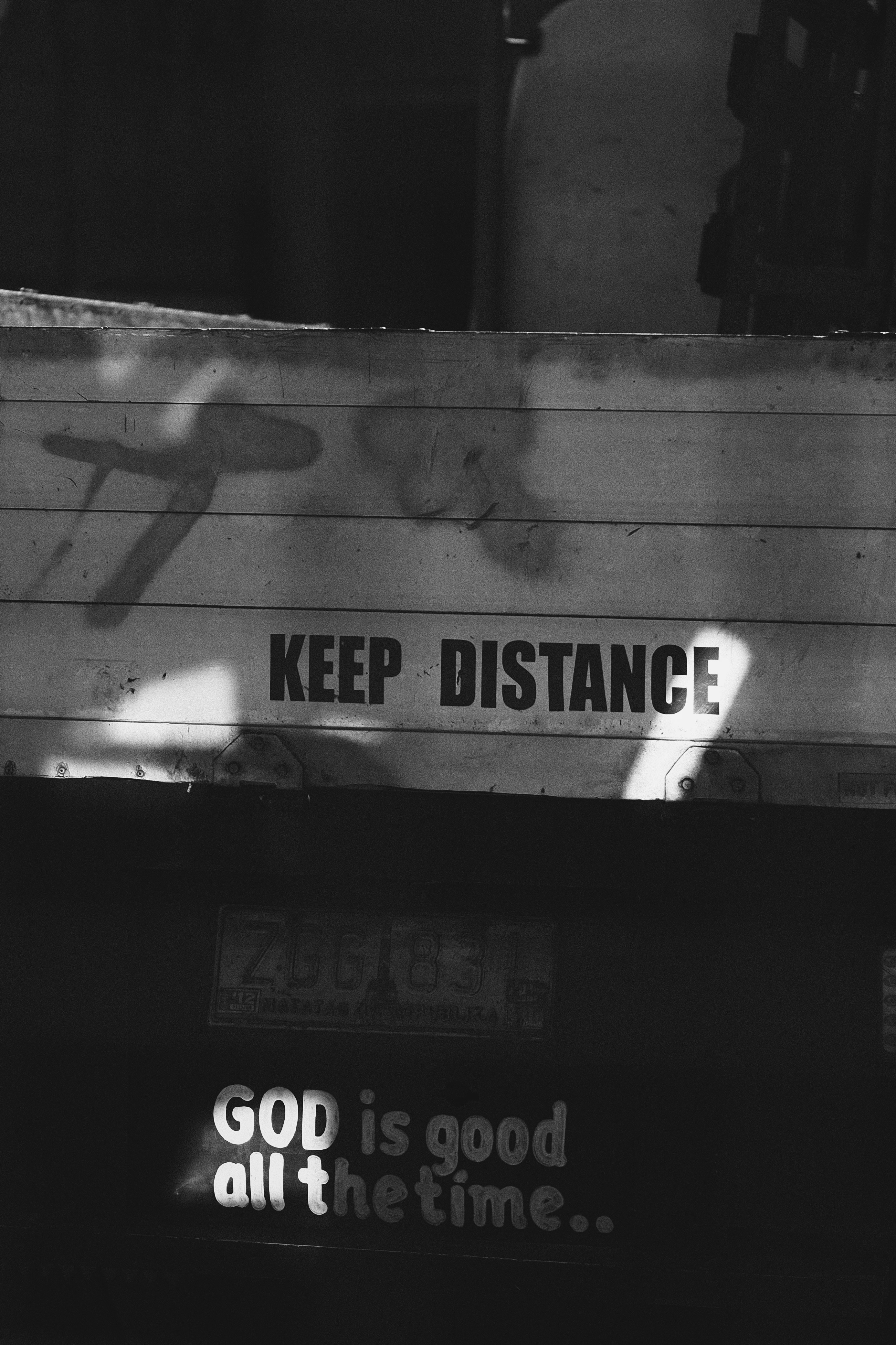 A black and white photo of a bus with the words keep distance on it ...
