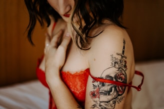 topless woman with red and black tattoo on her body