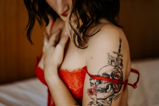 topless woman with red and black tattoo on her body