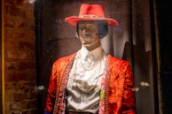 A chic Parisian-inspired outfit displayed on a mannequin against a rustic brick wall.