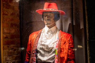 A mannequin dressed in a vibrant, stylish jacket displayed in a boutique setting