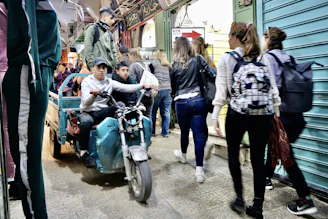 A stylish traveler walking through a vibrant Thai street market accompanied by a friendly companion.