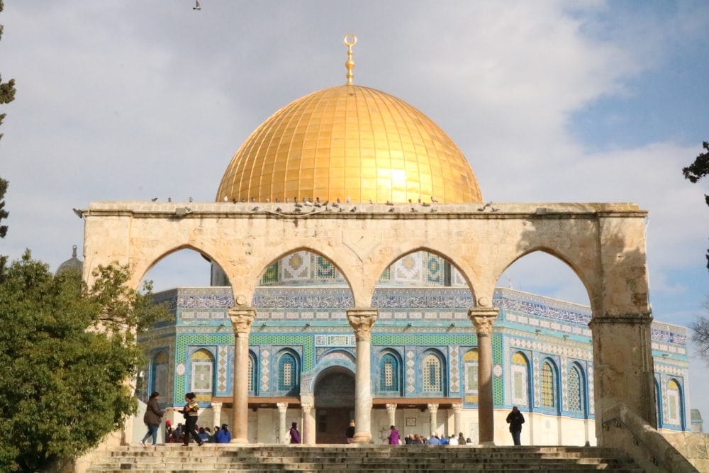 people walking near white and brown dome building during daytime