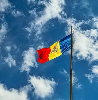 red blue and yellow flag under blue sky during daytime