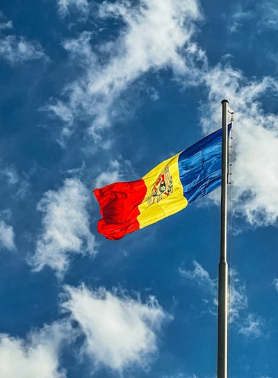 red blue and yellow flag under blue sky during daytime