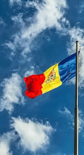 red blue and yellow flag under blue sky during daytime