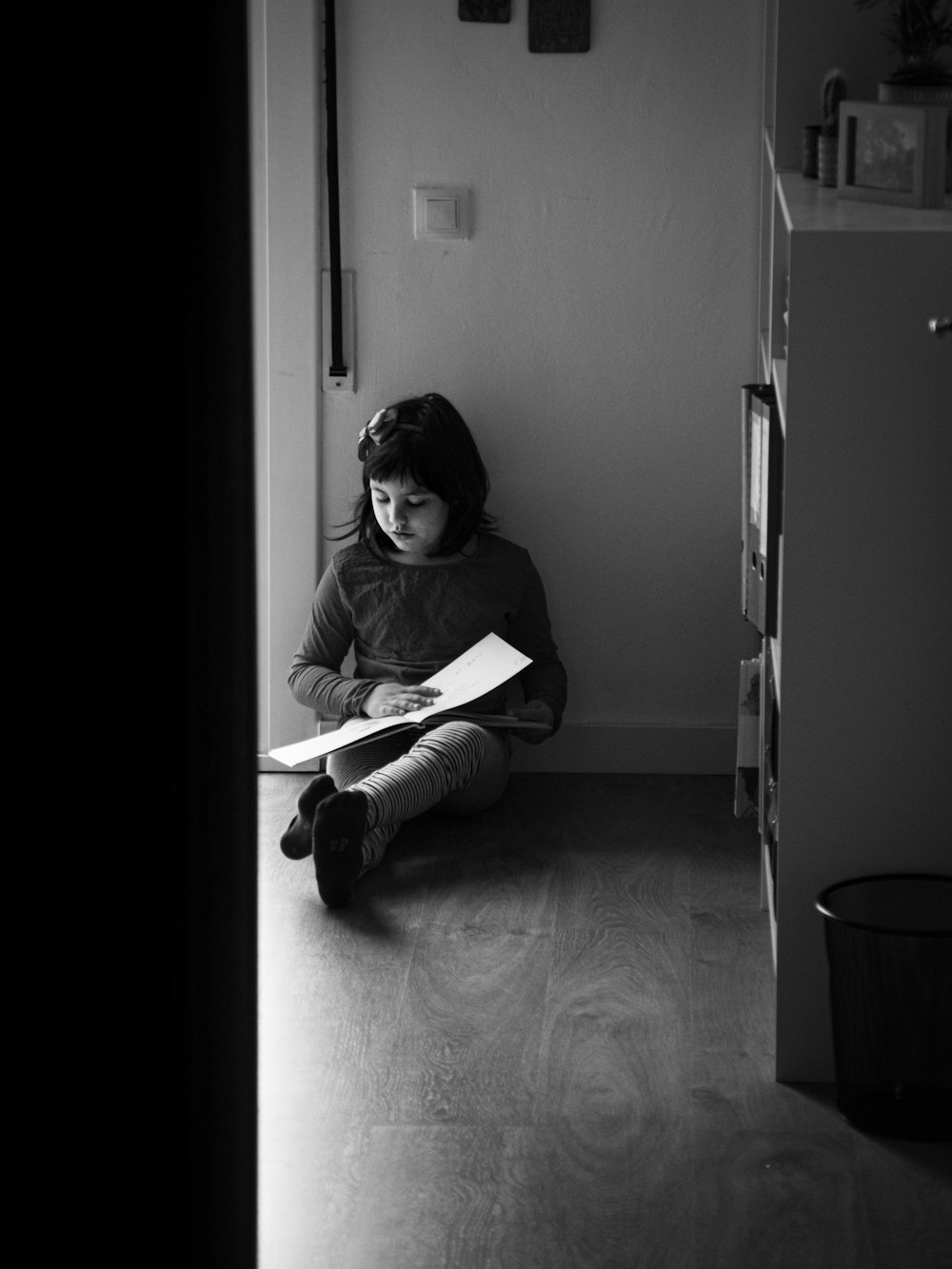 woman in white long sleeve shirt sitting on floor