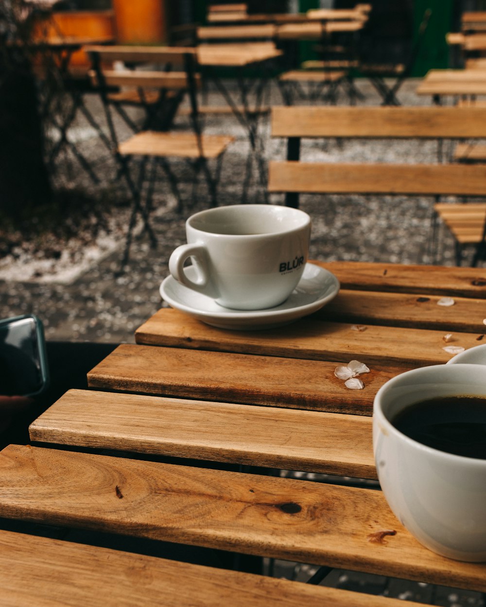 white ceramic cup on brown wooden table