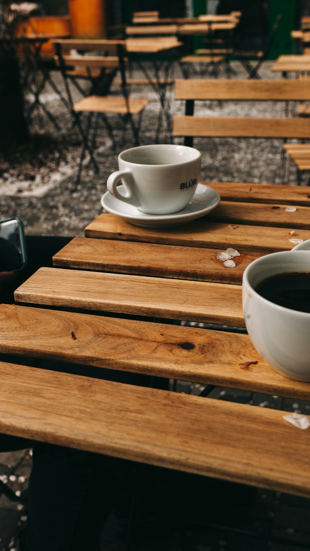 white ceramic teacup on brown wooden table