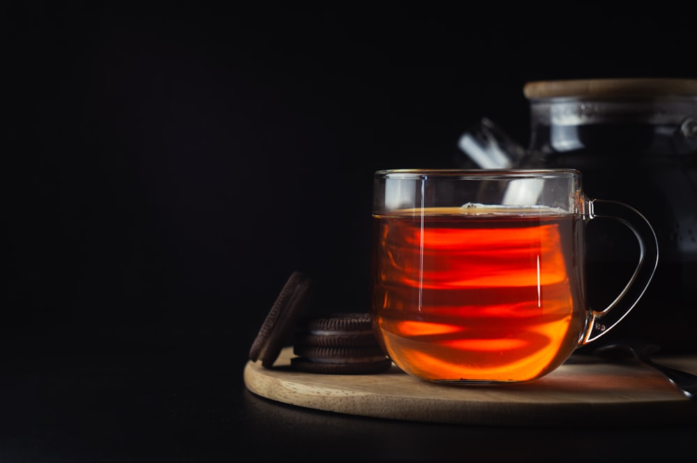 clear drinking glass with orange liquid inside