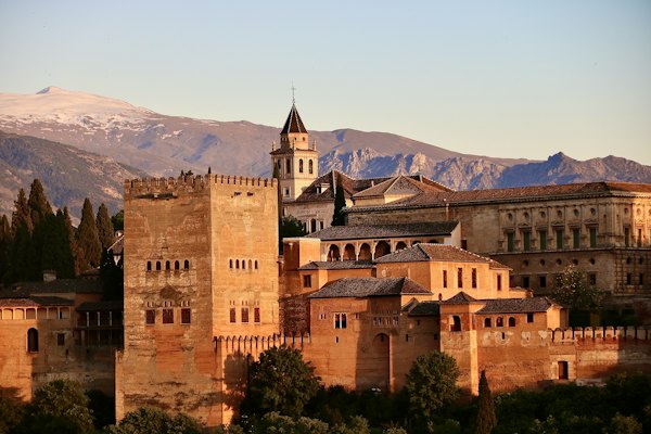Brown concrete building near green trees during daytime — Granada, Spain