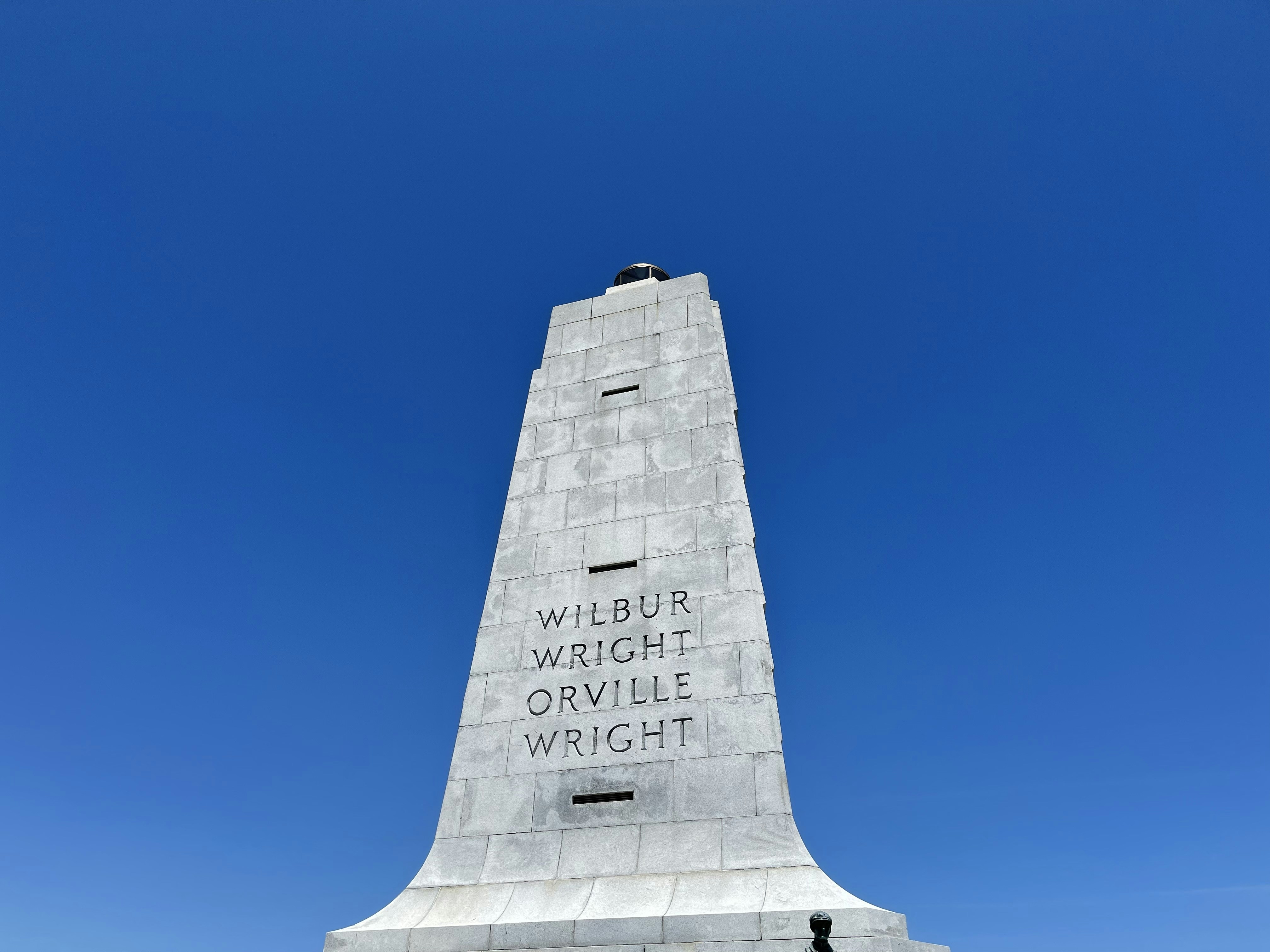 gray concrete cross under blue sky during daytime
