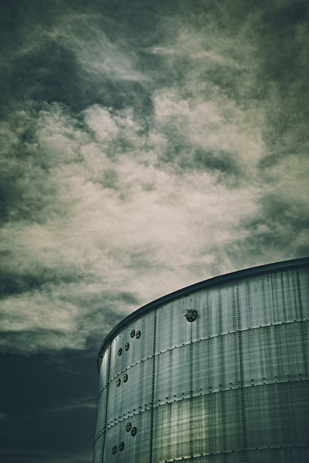 Construction en béton gris sous un ciel nuageux pendant la journée