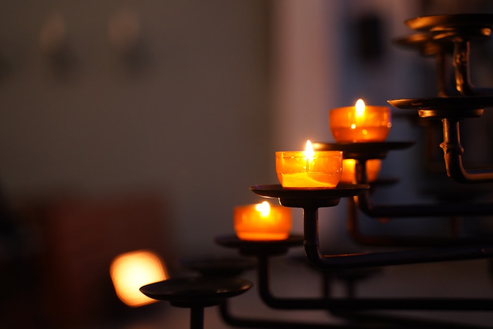 lighted candles on black metal candle holder