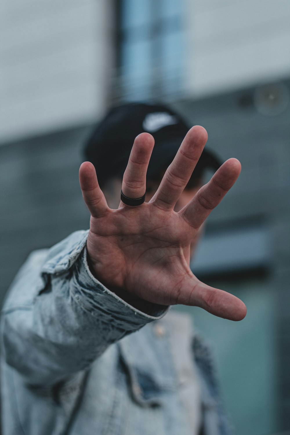 person in gray jacket showing left palm