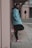 boy in blue hoodie and black pants wearing red shoes