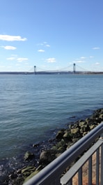 A newly built bridge spanning a river under a clear blue sky.
