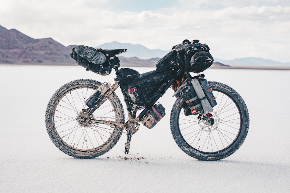 black and white mountain bike on snow covered ground