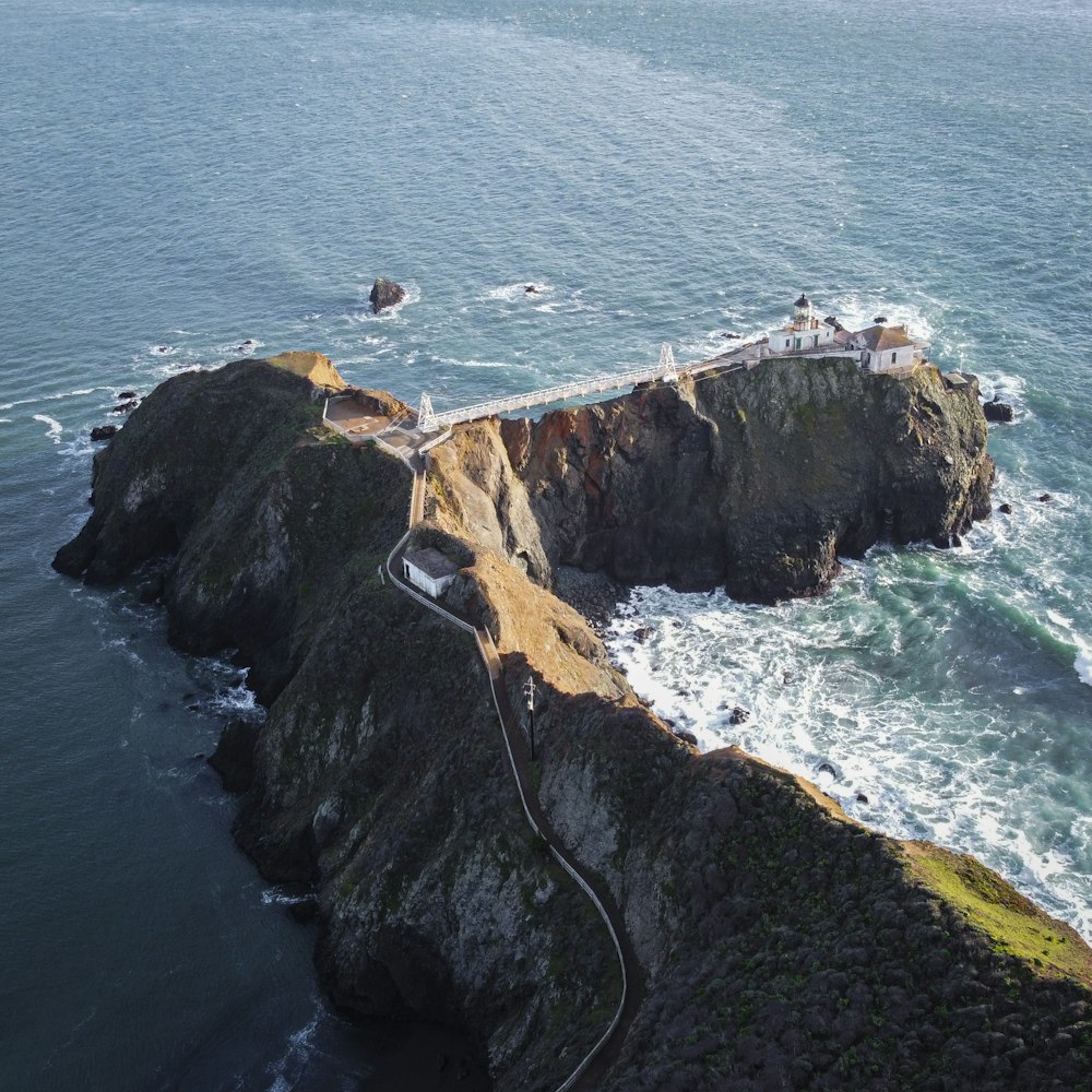 aerial view of brown and green mountain beside body of water during daytime