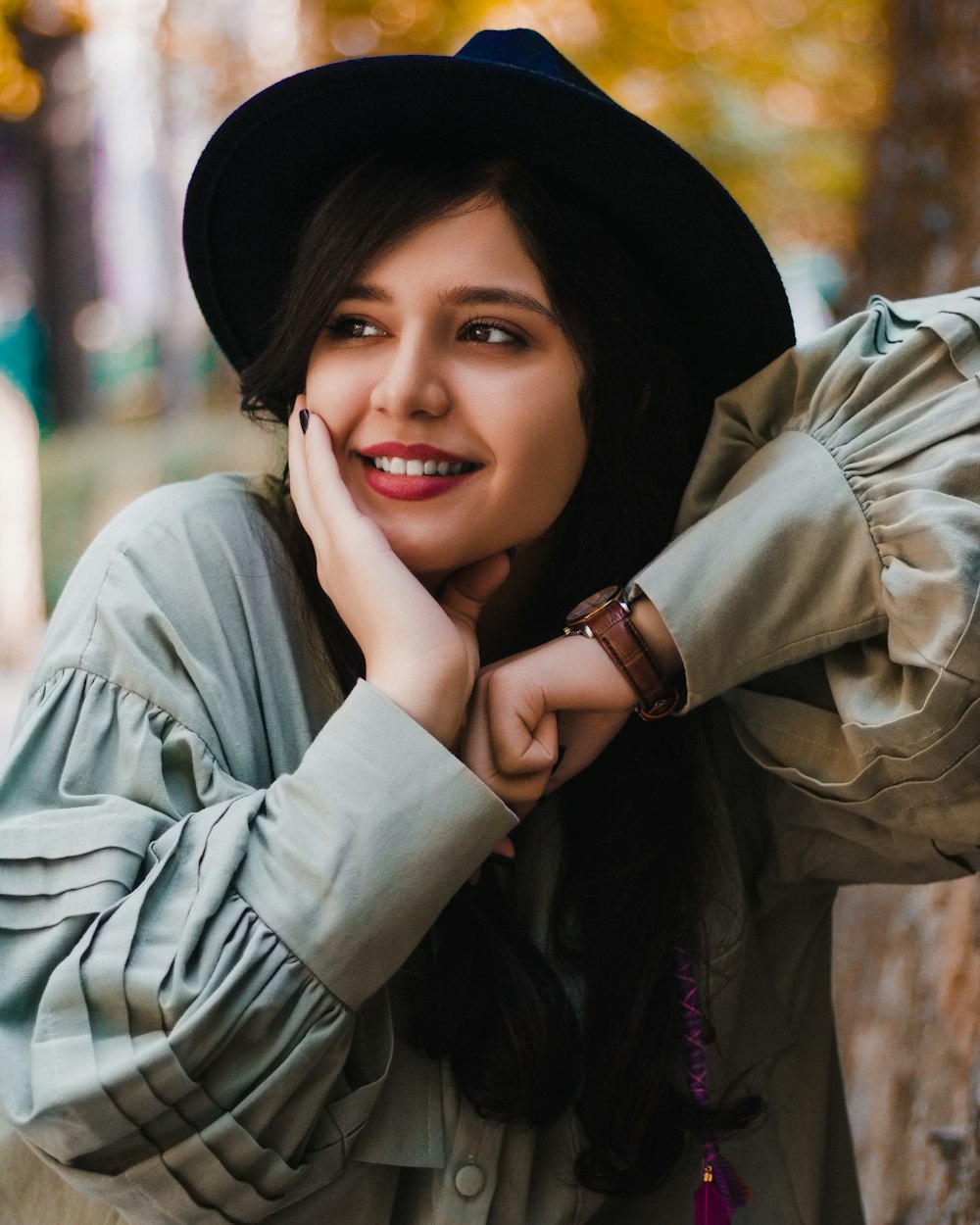 woman in gray jacket wearing black hat