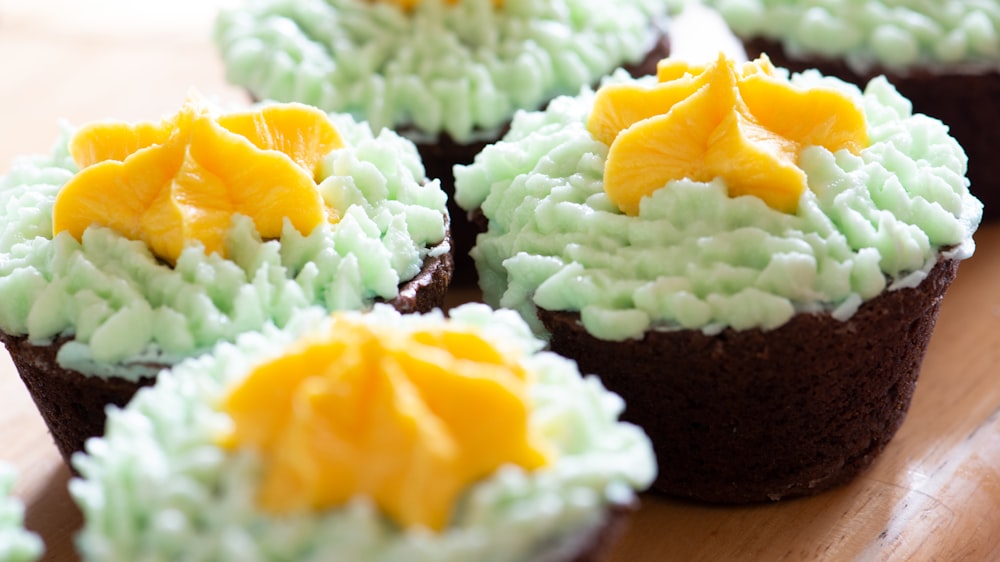 Tarta amarilla y verde con glaseado blanco en la parte superior