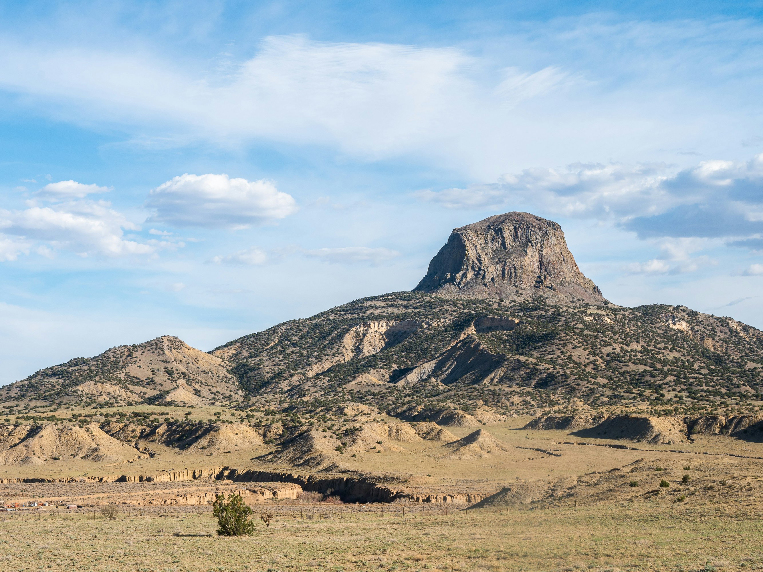 brown and gray mountains under white clouds and blue sky during daytime