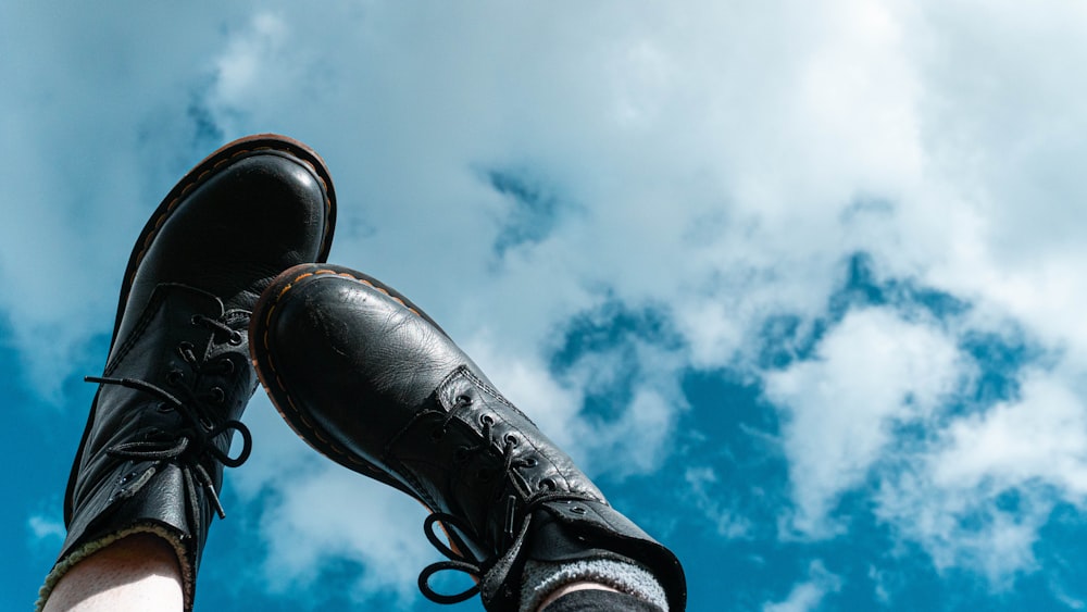 black leather boots under white clouds and blue sky during daytime