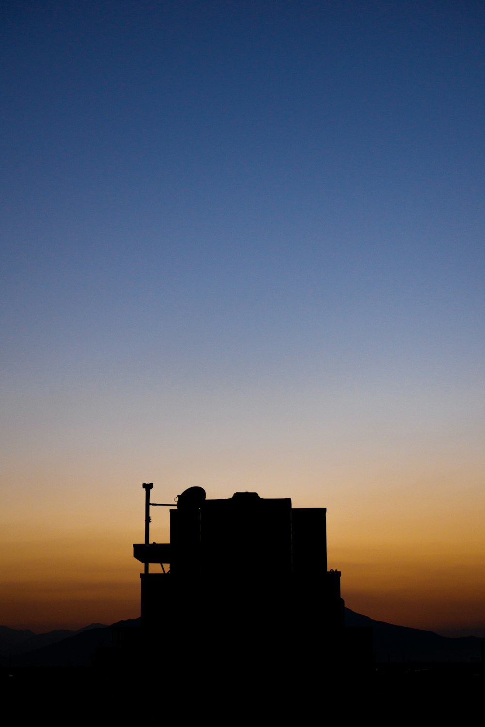 silhouette of building during sunset