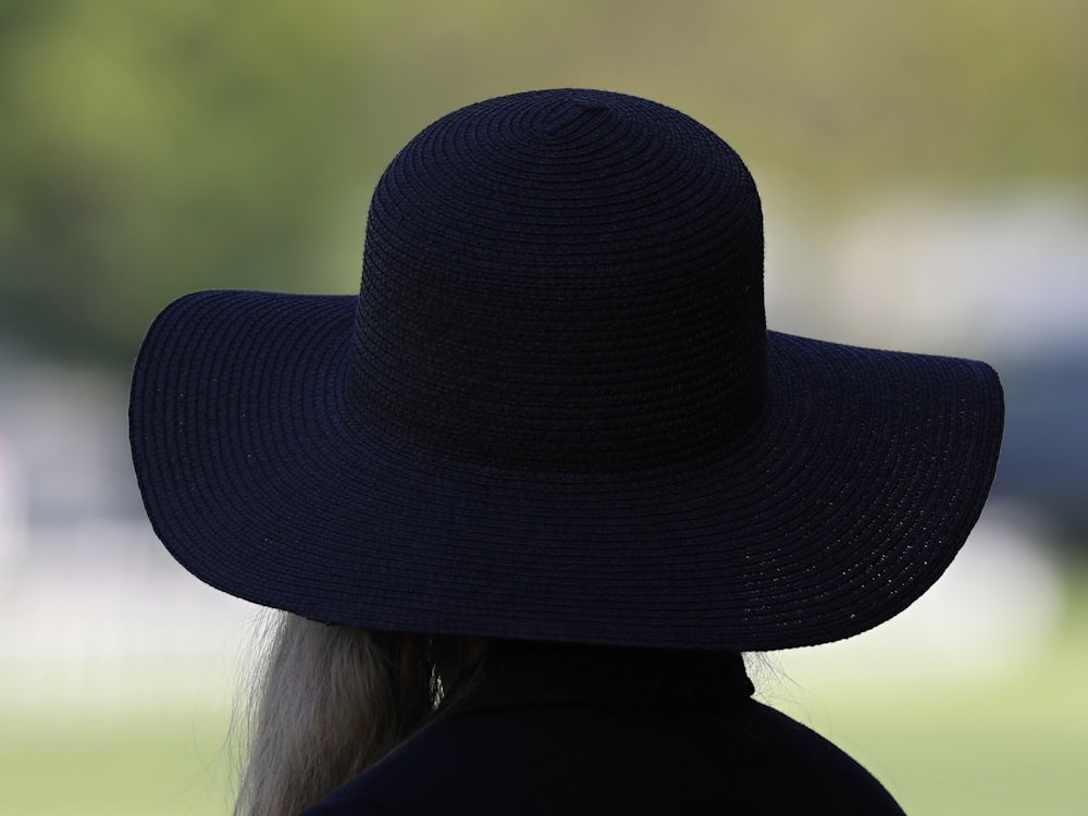 woman wearing black fedora hat