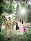 A happy family enjoying time together outdoors in a sunny park.
