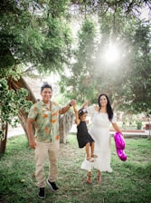 A happy family wearing matching outfits in a sunny park.