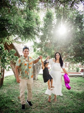 A happy family wearing matching outfits in a sunny park.