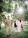 A happy family wearing stylish outfits in a bright park setting.
