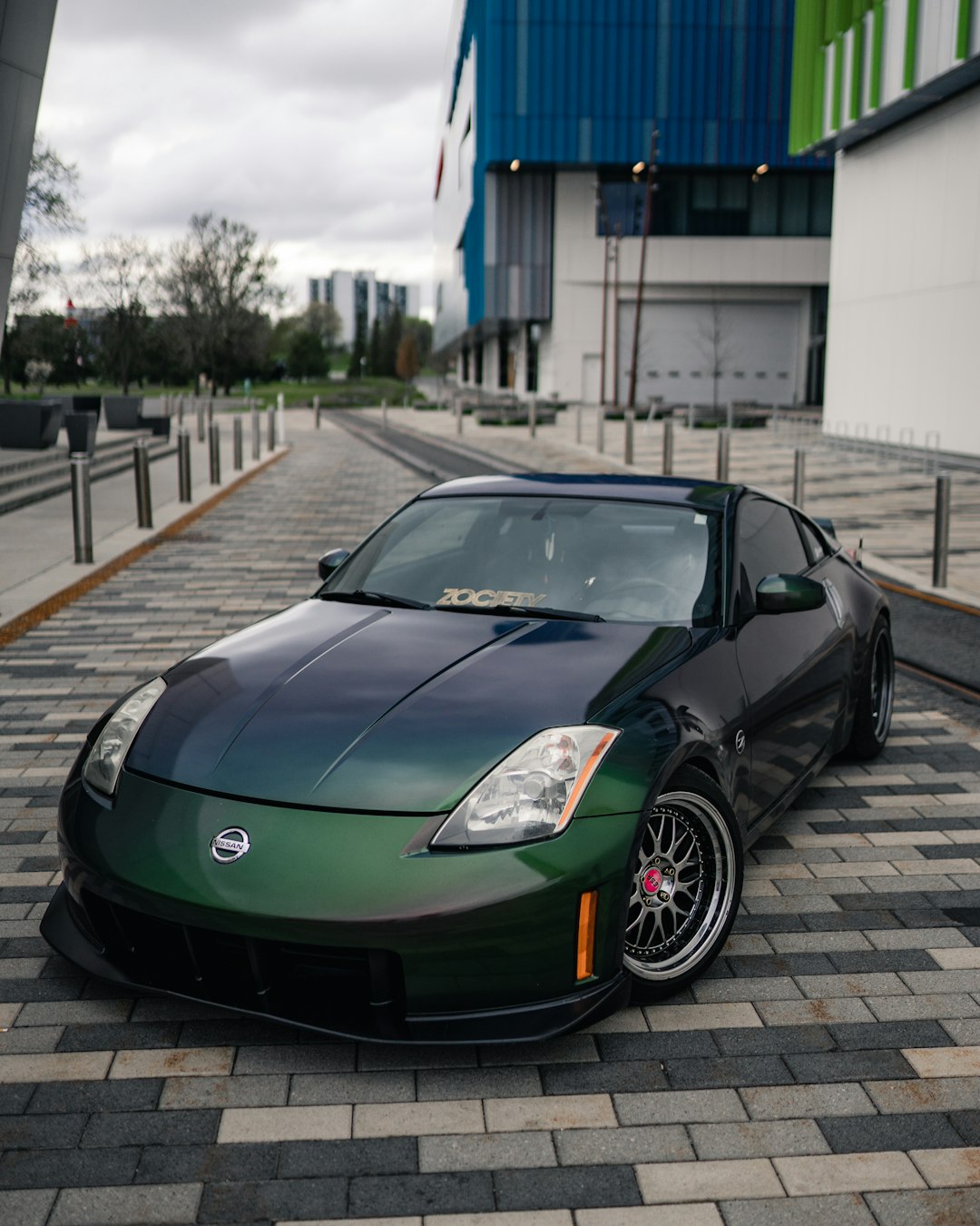 green porsche 911 parked on sidewalk during daytime