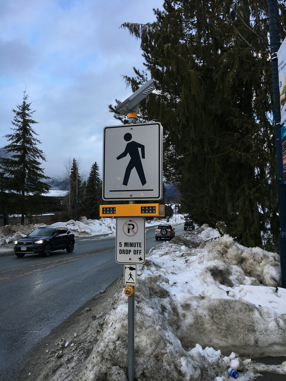 black car on road near snow covered ground during daytime