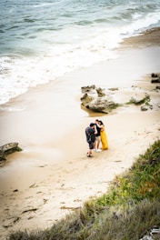 Photographer capturing a couple's intimate moment at a sunlit beach wedding in Mauritius.