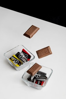 A collection of Death Day Candy wrappers laid out on a dark wooden table with numerology charts.